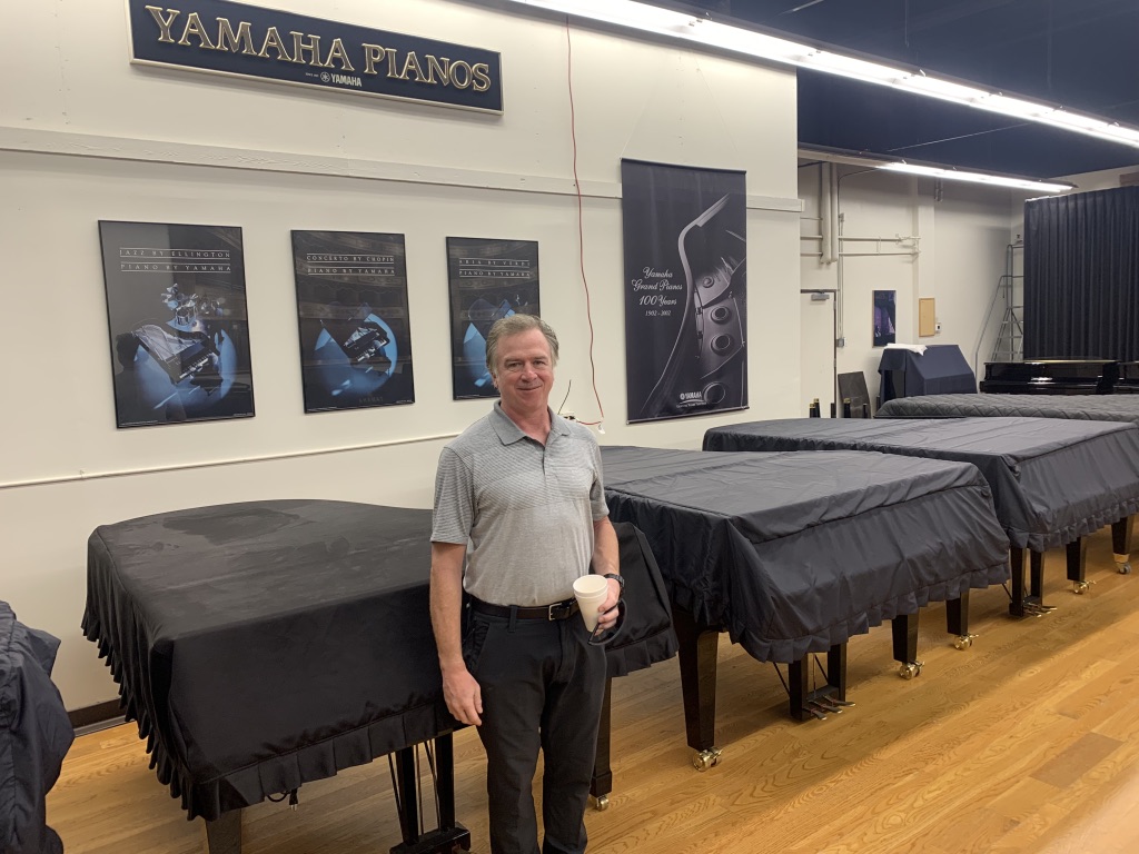 Technician in a piano showroom